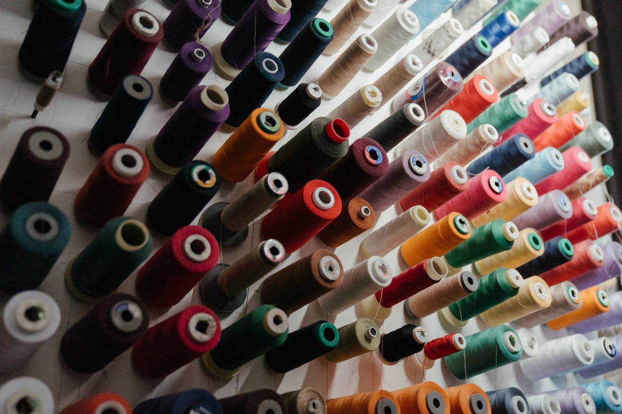 A vibrant array of sewing threads neatly organized on spools in various colors.